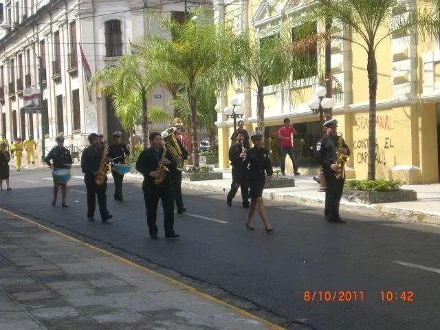 Formación de Bandaliza con saxofones y percusión recorriendo una calle